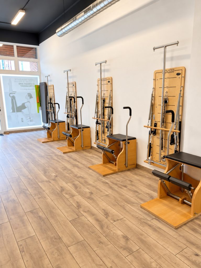 Paneles Spring Wall en la pared y Combo Chair en el centro Alegría de Pilates Esplugues
